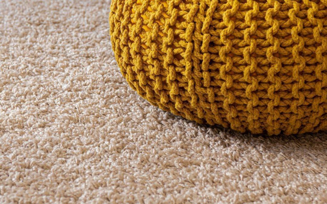 Yellow cushion on tan carpet